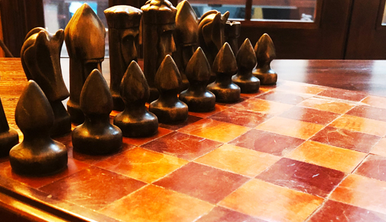 Wooden chess pieces on a chess board. Data Strategy