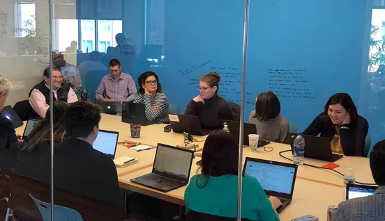 A conference room filled with professionals - center of excellence