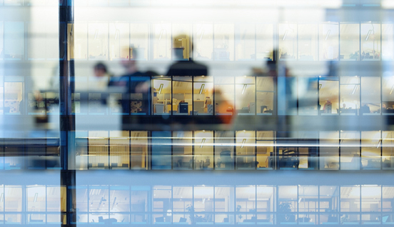 An office building looking out to another office building with windows. Maximize performance management.