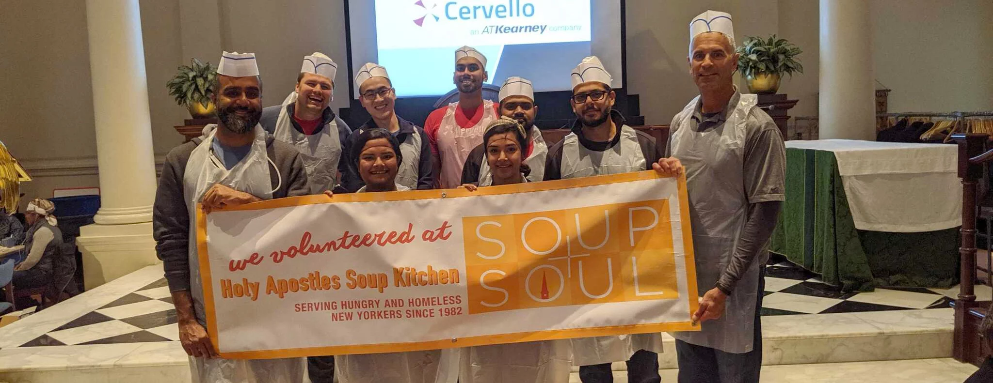 A group of people standing with a soup kitchen sign - win with data